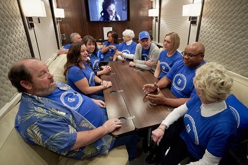 CAR members hold a meeting inside the Riding with the Brand motorcoach in Denver.