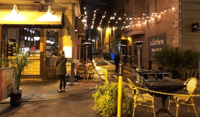 String-lights allowed for socially-distant alleyway and on-street dining after dark in Philadelphia.