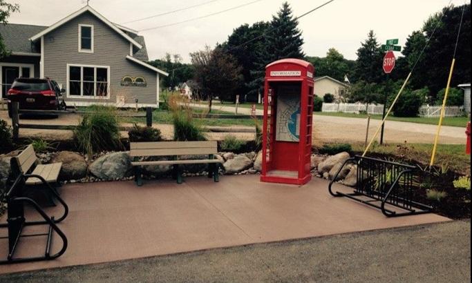 Benches and an English phone booth featured in the Trailhead Pocket Park, Grand Traverse Bay, MI