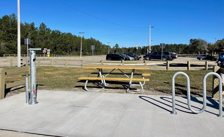 Bike repair station featuring seating, bike rack, and greenery - DeBary, FL