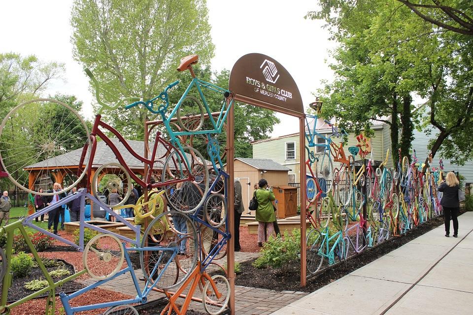 Entrance to the Boys and Girls Club in Mercer County, NJ featuring a colorful fence made of bicycle parts.