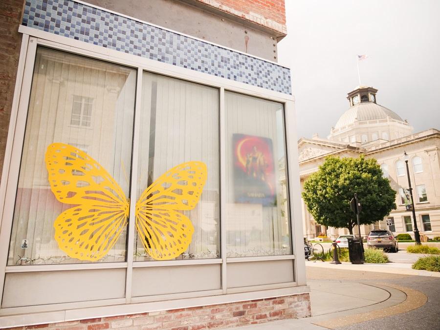 Window at a shop in Lebanon, Indiana featuring a yellow butterfly artwork