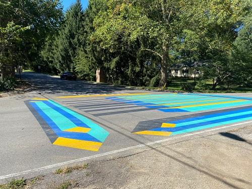 Colorful crosswalk art at the entrance to the temporary stone trail in the Town of Cumberland, IN