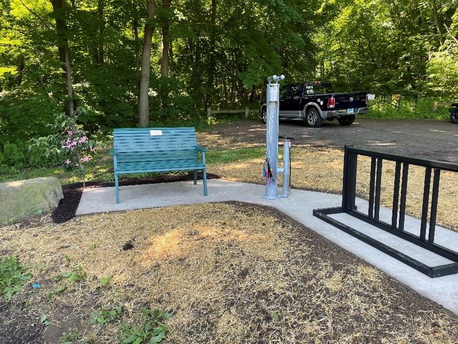 A bench, bike filling station and bike rack at Dividend Pond Trails in Rocky Hill, CT