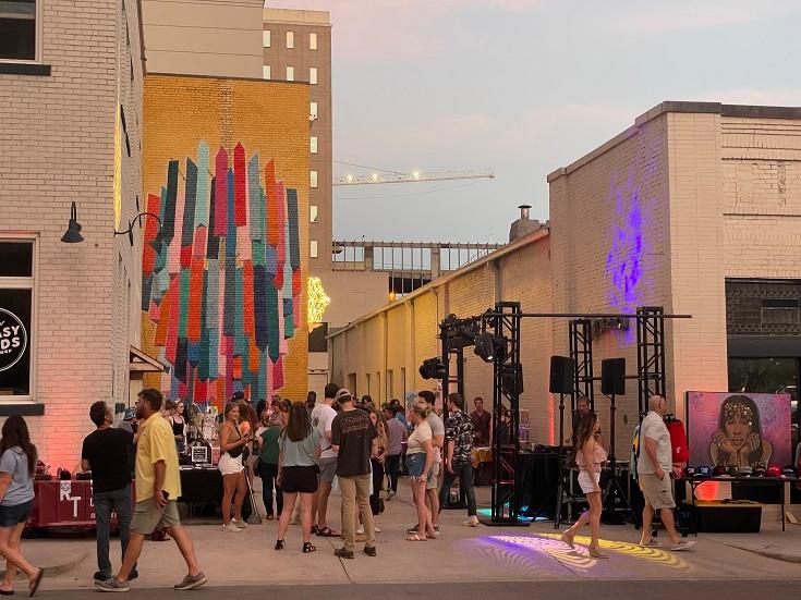 The Drop Metal chandelier sculpture lights up Chandelier Alley just behind the now-famous chandelier mural.