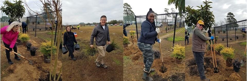 A group of CCAR REALTORS® and affiliate volunteers help plant trees and bushes alongside the fence in the East Bay Park