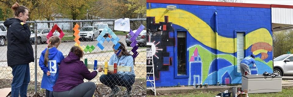 Three adults and one girl decorating a fence; and a man wearing a blue realtor shirt painting a mural on the side of a building.