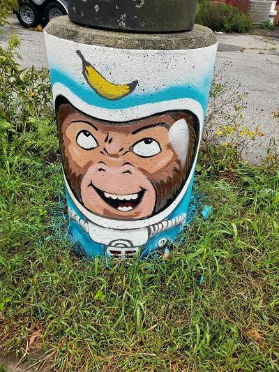 A lamppost is livened up with artwork depicting a monkey astronaut.