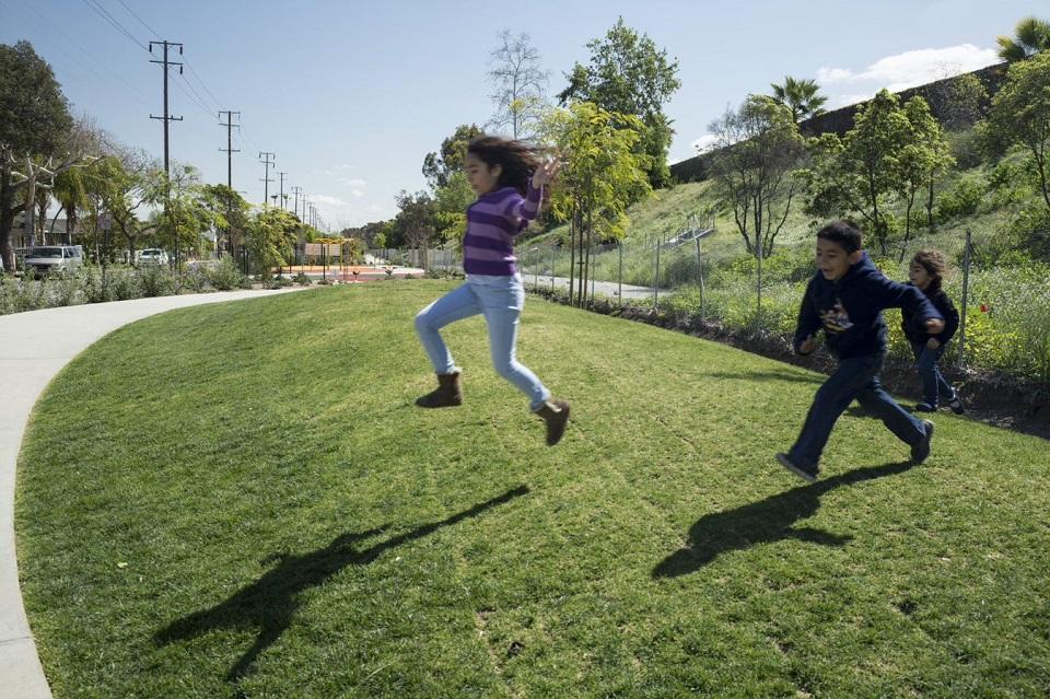 Children playing at the Ricardo Lara Linear Park in Lynwood, CA