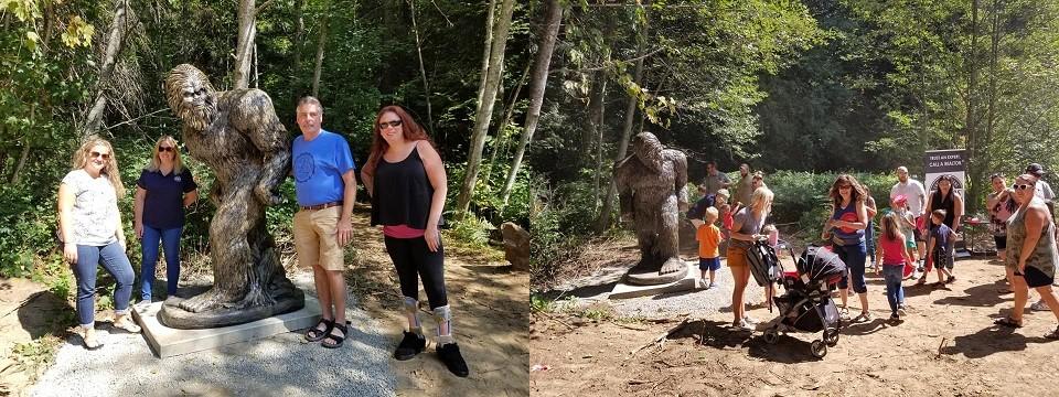 The Mayor of Rathdrum and REALTORS® standing next to a giant statue of a Sasquatch / People at the entrance to the storytrail