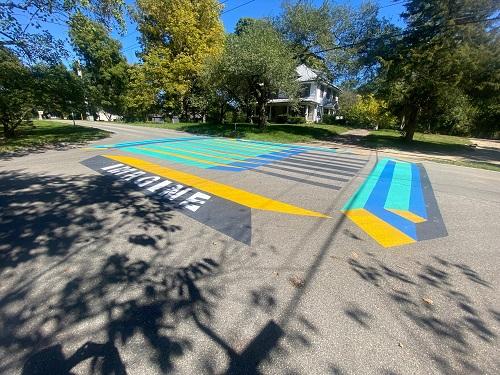 A colorful temporary crosswalk art in the Town of Cumberland