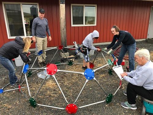 Volunteers assembling playground equipment at the Viola Community Center, ID