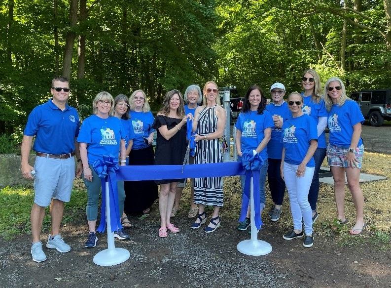 Rocky Hill town Mayor performing the ribbon cutting ceremony at Dividend Pond Trails along with the CEO and members of GHAR. 