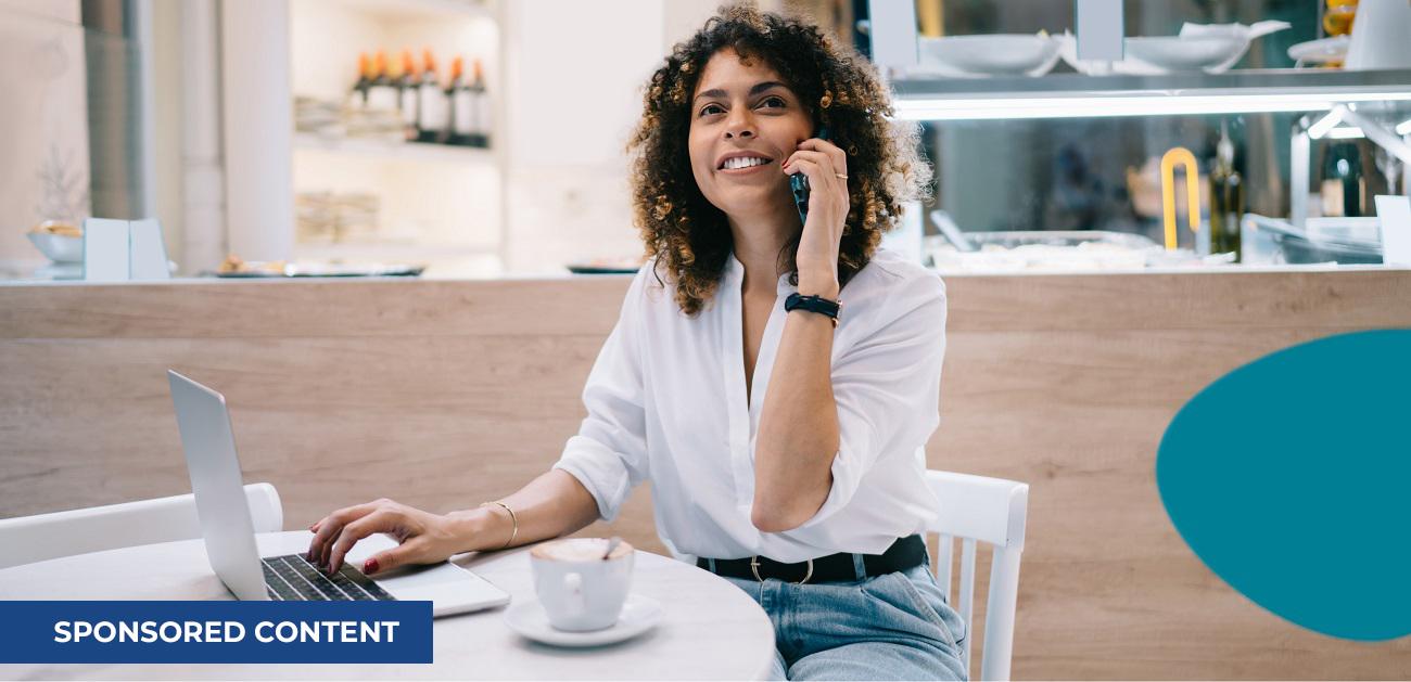 Businesswoman talking on phone with laptop