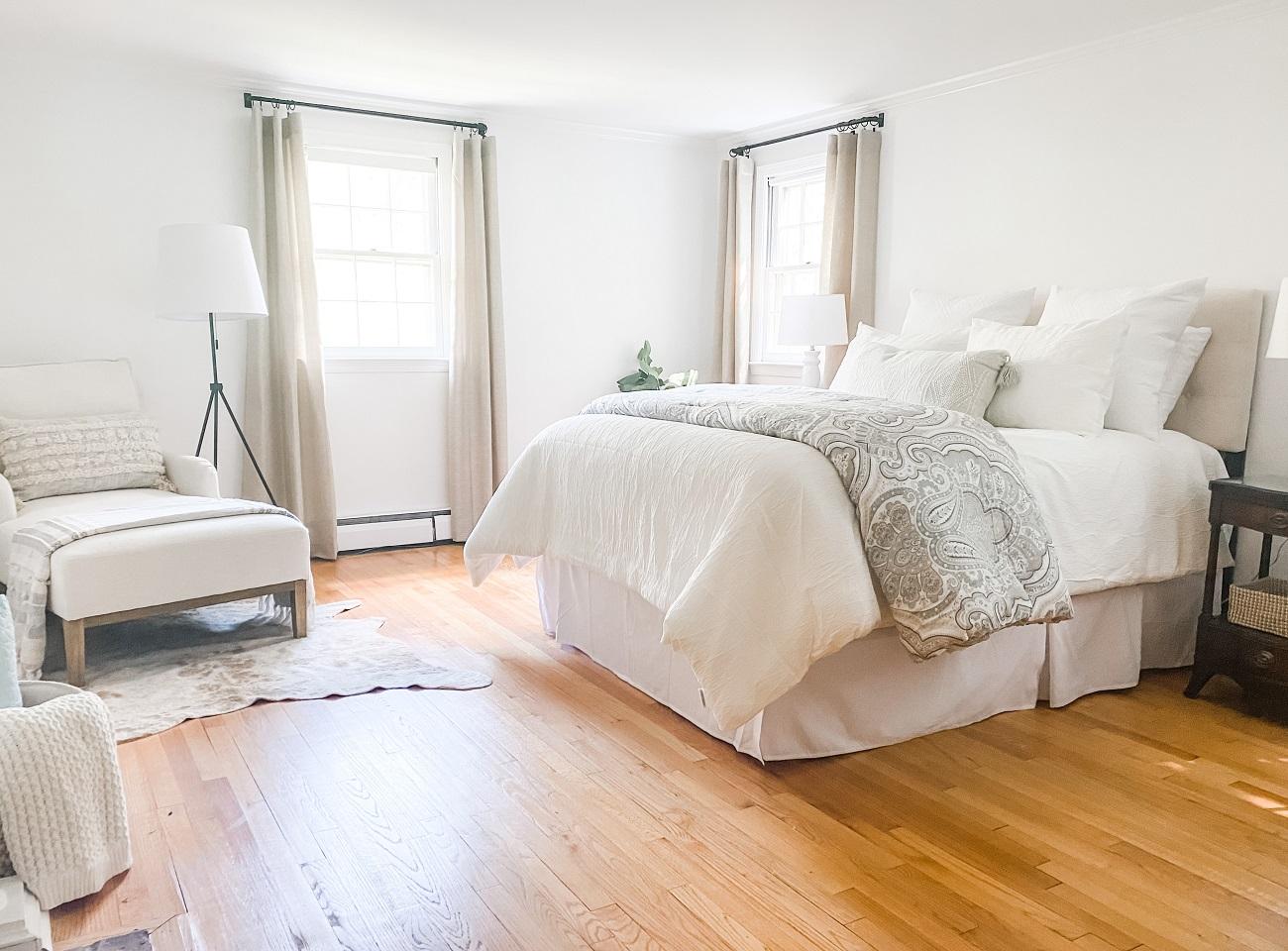 White interior walls and furnishings in redesigned and staged primary bedroom after image