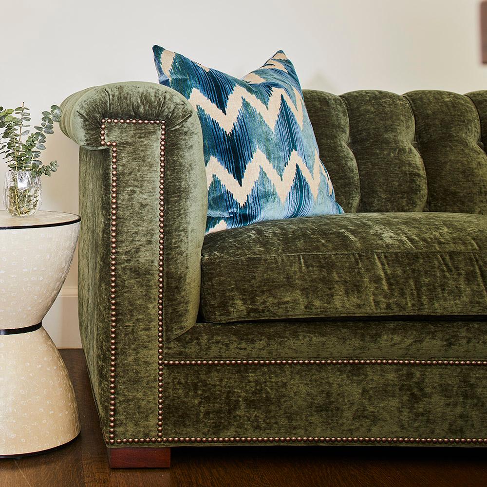 Green couch with zig-zag pillow