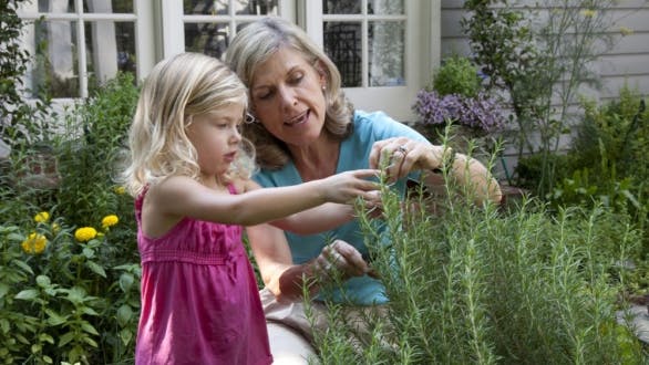 grandmother in garden with granddaughter