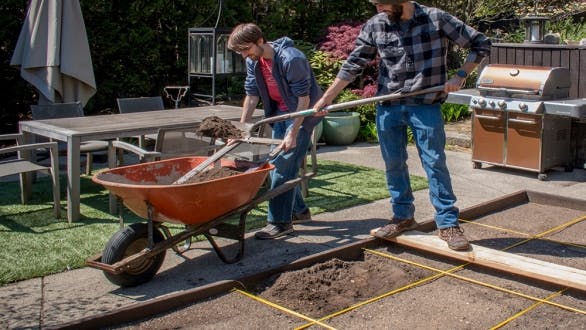 father and son prepare raised vegetable bed