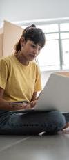 Woman Searching for Homes on a Laptop