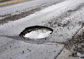 Image of a pot hole on a busy street