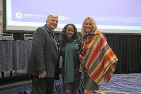 Presenters Ron Phipps (right) and Natalie Davis (middle) pose with a training participant for a photo