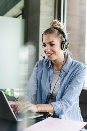 Woman making call with computer using a headset 