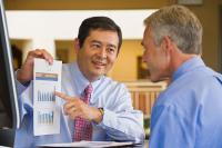 Businessman Showing Chart to Coworker