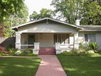 Modest craftsman style house with red brick walkway