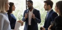 African American man talking to business colleagues