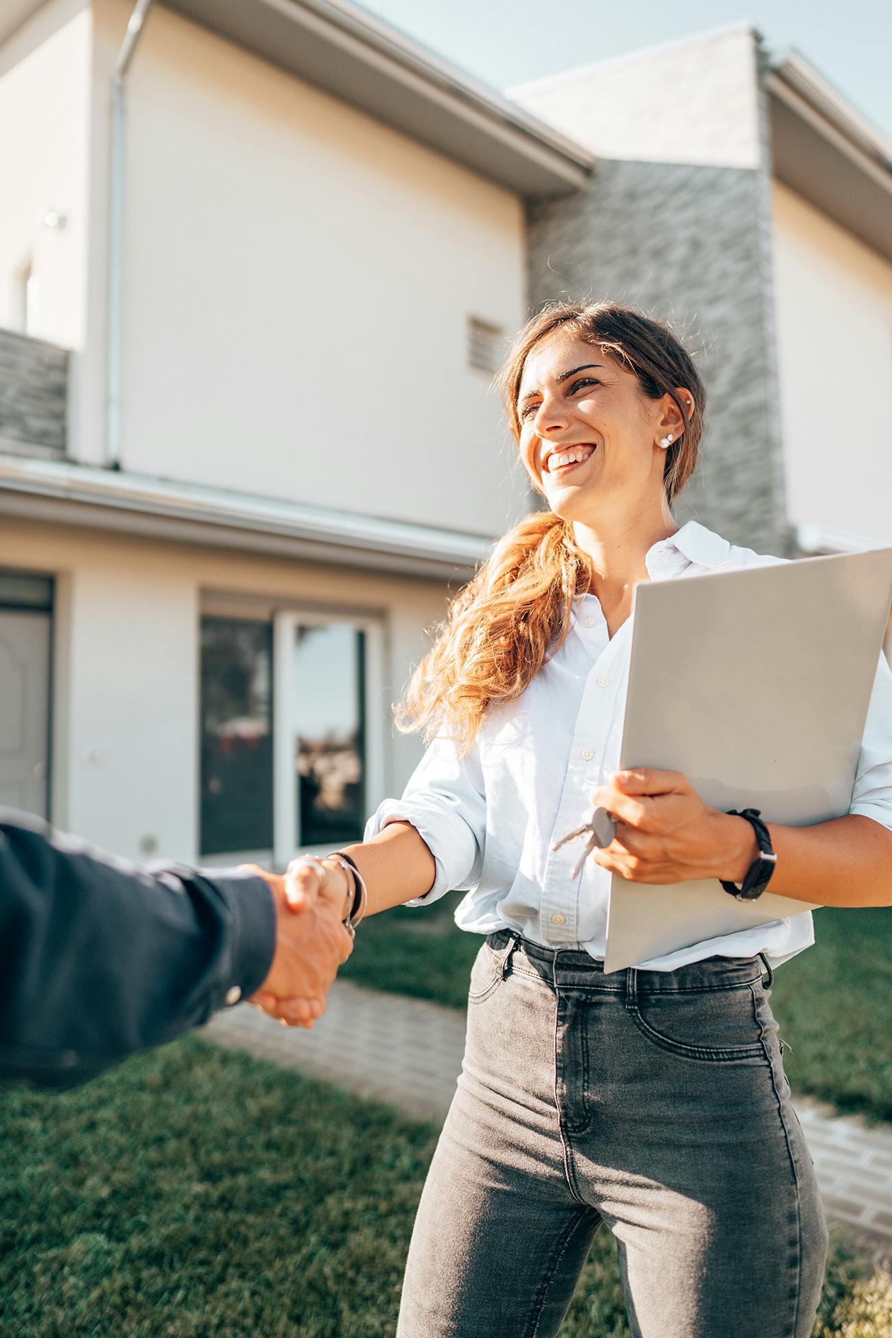 Woman holding folder and shaking hands