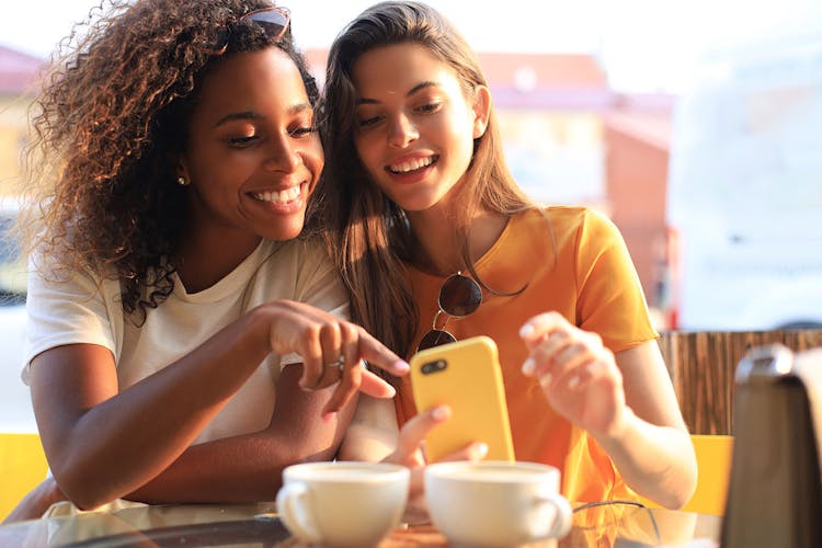 Two Women Smiling at Smartphone