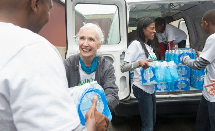 Disaster Relief Volunteers Passing Out Water