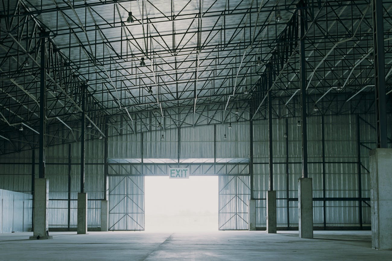 Empty warehouse, light shining through door