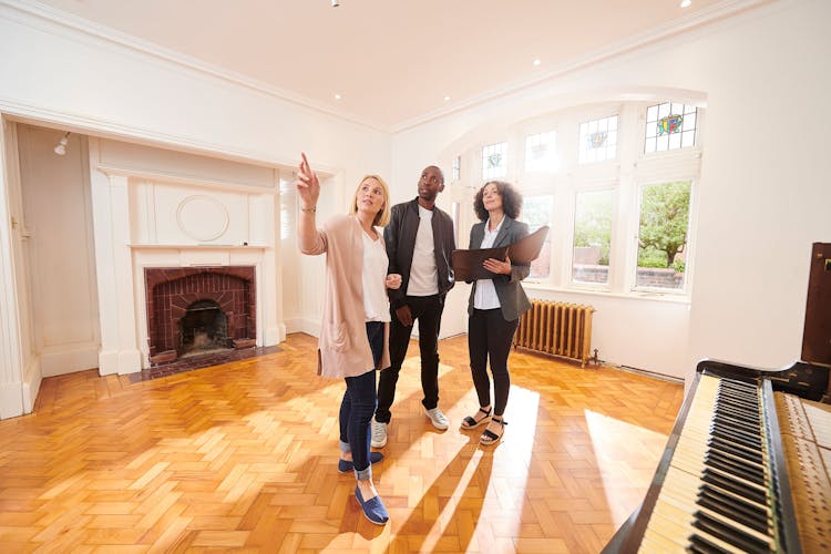 House hunting couple with agent in vintage home