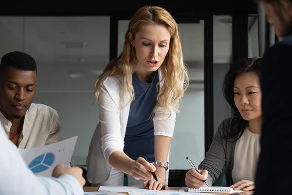 Woman in meeting explaining something to colleagues