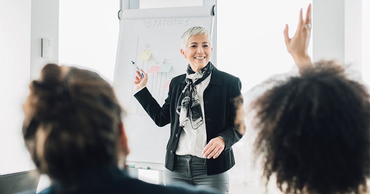 Woman giving a presentation to an office group