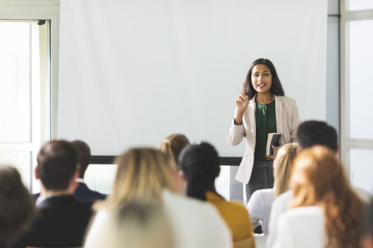 Woman teaching adults in a classroom