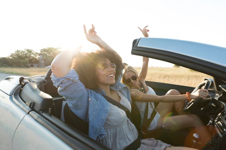 Women on road trip in convertible