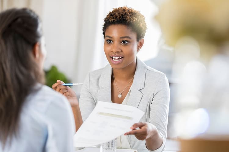 Two women discussing paperwork Two women discussing paperwork
