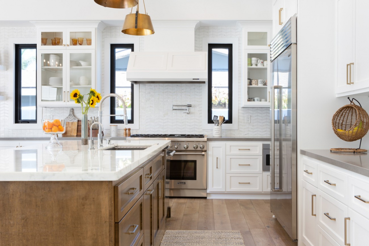 White countertop kitchen island with built in sink.